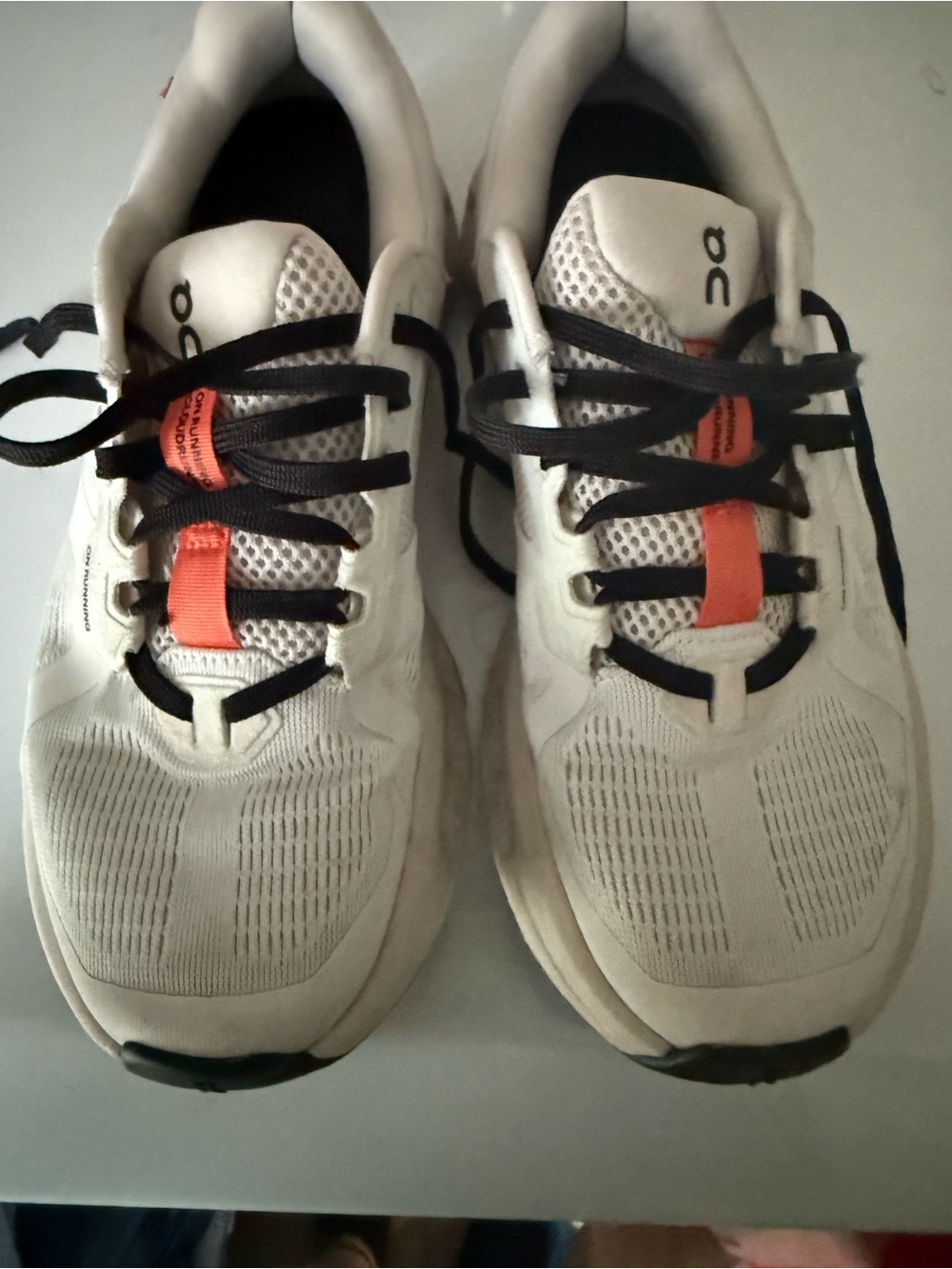 On Running women’s  White Sneakers with Black Laces and Orange Tongue Tabs